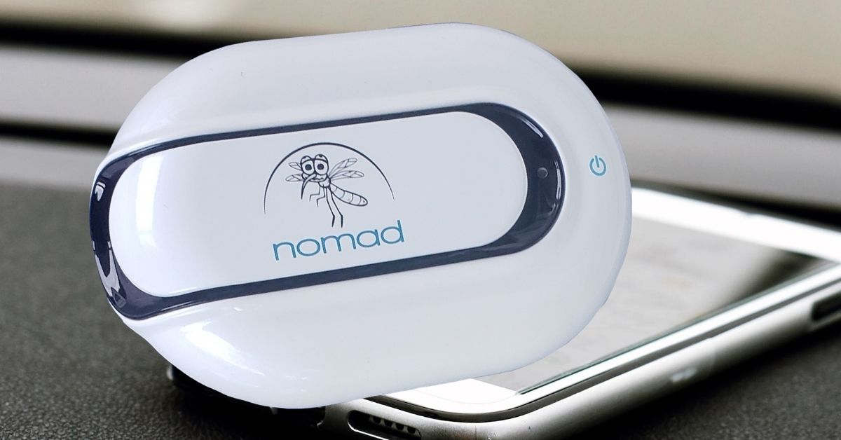 Eco-friendly mosquito repellent placed on a wooden table outdoors.